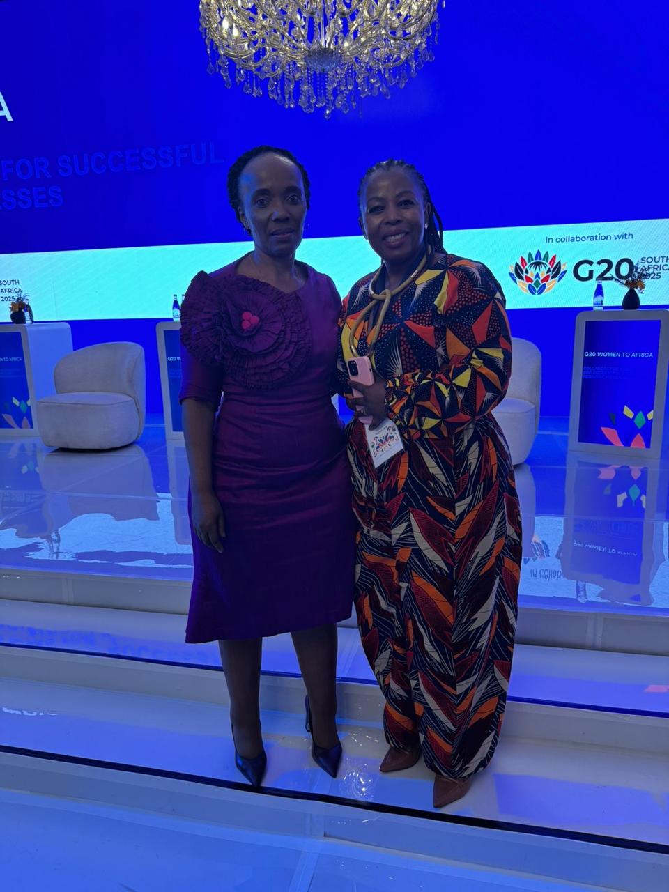 Two models wearing women's black cotton crewneck tee and off-white cotton crewneck tee.